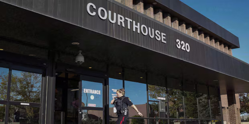 A police officer arrives at the provincial court building in Lethbridge